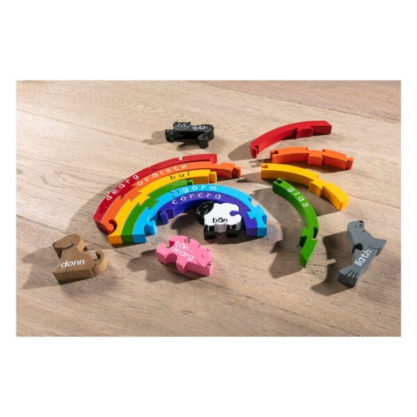 Rainbow Jigsaw Puzzle for Kids with Irish language words for each color, displayed on the floor
